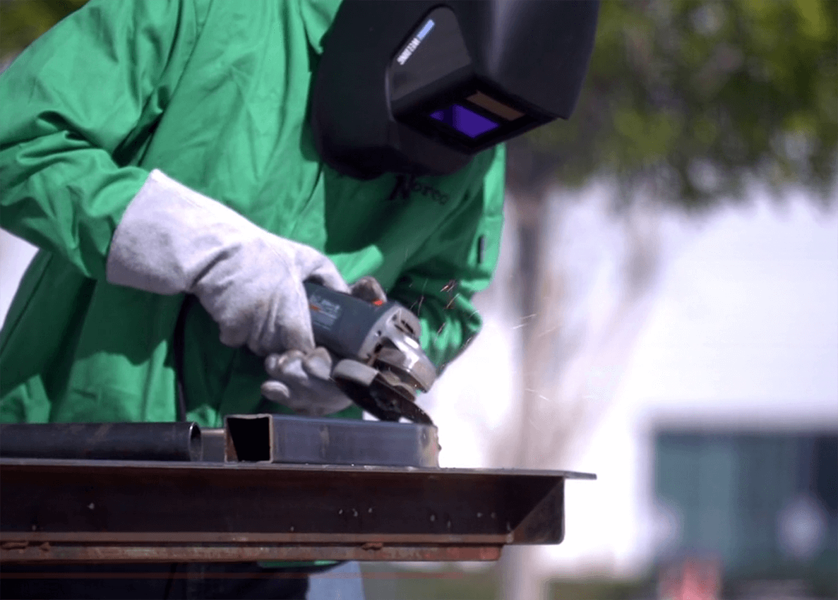 Photo of worker using grinder tool
